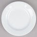A close up of a Tuxton Alaska bright white wide rim china plate.