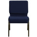 A navy blue church chair with gold dots on the fabric.