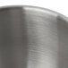 A close-up of a KitchenAid stainless steel mixing bowl with a brushed finish.