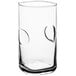 A close-up of a clear Acopa highball glass with a thumbprint design.