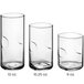 A group of Acopa clear highball glasses with a white liquid in one.