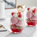 Two Acopa tall stemless wine glasses filled with ice cream and fruit.