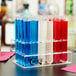 A clear Choice test tube rack filled with different colored liquids.
