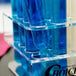 A Choice test tube rack holding clear test tubes filled with blue liquid.