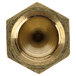 A close-up of a hexagon shaped brass nut threaded onto a circular object.