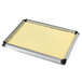 A rectangular metal tray with a yellow layer of cake inside.