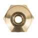 A close-up of a brass hex nut with a circular opening.