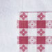 A white tablecloth with red and white checkered pattern.