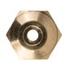 A close-up of a brass threaded nut with a circular object inside.