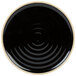 A black stoneware plate with a white spiral design in the center.