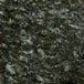 A close up of an Uba Tuba granite table top with black and white speckles.