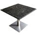 A metal table with a square Uba Tuba granite top.