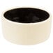 A white stoneware bowl with a black interior.