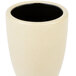 A white stoneware cup with a black inside.