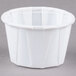 A Solo white paper souffle cup on a gray surface.