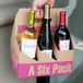 A 6 pack of wine bottles in a cardboard carrier.