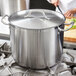 A Vigor stainless steel lid on a large pot.
