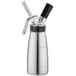 A stainless steel iSi whipped cream dispenser with a black lid and handle.