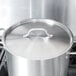 A Vigor stainless steel pot lid on a large pot.