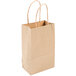 A bundle of Duro natural kraft paper shopping bags with handles.