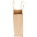 A bundle of Duro natural Kraft paper bags with handles.