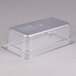 A Carlisle clear polycarbonate food pan with a lid on a counter.