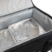A Sterno black catering food carrier with foil in it.