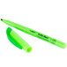 A close-up of a Bic Brite Liner fluorescent green highlighter pen and cap.