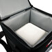 A black Sterno insulated food carrier with a white foam box inside.