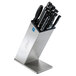 An Edlund slanted stainless steel knife block with knives in it.