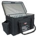 A black and grey Sterno Delivery Deluxe insulated food carrier with a black handle and zipper.