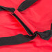 A close up of a red Rubbermaid insulated delivery bag with a black zipper.