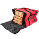 A red Rubbermaid insulated delivery bag with pizza boxes inside.