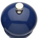 A blue pepper mill with a silver top.