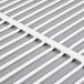 A close up of a white wire grid shelf.