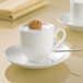 A Villeroy & Boch white bone porcelain saucer with a cookie on top.