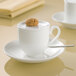 A white Villeroy & Boch bone porcelain cup with a cookie on top.