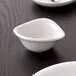 A close up of a white Villeroy & Boch Dune small bowl on a black table.