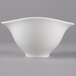 A white Villeroy & Boch porcelain bowl with a curved bottom on a gray background.