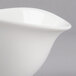 A close-up of a Villeroy & Boch white porcelain bowl with a curved edge.