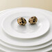 A group of white Villeroy & Boch Stella Hotel bone porcelain plates with a couple of speckled quail eggs on them.