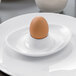 A brown egg in a Villeroy & Boch white bone porcelain egg cup.