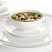 A close up of a Villeroy & Boch white bone porcelain saucer on a white background.