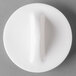A white porcelain teapot lid with a white knob.