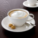 A close up of a white Villeroy & Boch porcelain cup of coffee with a foamy surface.