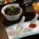 A Villeroy & Boch Terra Porcelain bowl of salad on a table with a plate of dips.