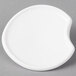 A white porcelain lid with a circular cut out.