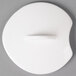 A white porcelain lid with a circular hole in the middle.
