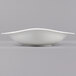 A Villeroy & Boch Dune white porcelain deep bowl with a curved edge on a gray background.