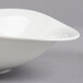A close-up of a Villeroy & Boch white porcelain deep bowl with a curved edge.